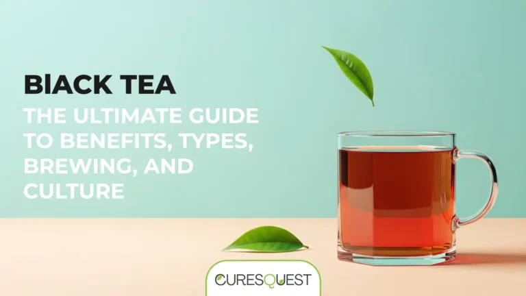 A mug of dark, brewed black tea sits on a beige table. Two green tea leaves float above the mug, with another resting on the table in front of it. The background is a soft blue-green. Black text in the upper left corner reads, "BLACK TEA," with a smaller subtitle below it that says, "THE ULTIMATE GUIDE TO BENEFITS, TYPES, BREWING, AND CULTURE." At the bottom of the image is the logo for Curesquest.