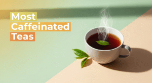 An image illustrating what tea has the most caffeine. The left side features a light green background with the text 'Most Caffeinated Teas' in white and orange boxes. The right side has a light tan background, showcasing a white cup of steaming dark tea with a single green tea leaf floating in it. Two fresh green tea leaves rest on the surface next to the cup.